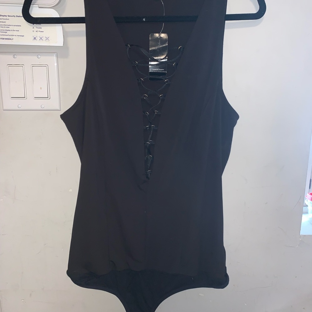 Black bodysuit with snaps. Lace up chest.